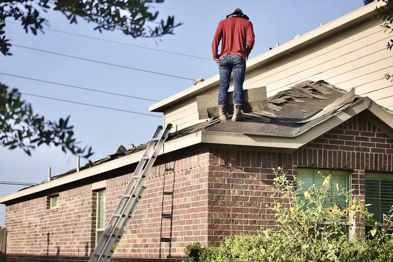 Professional roofer working on a residential roof in Rocky Glen